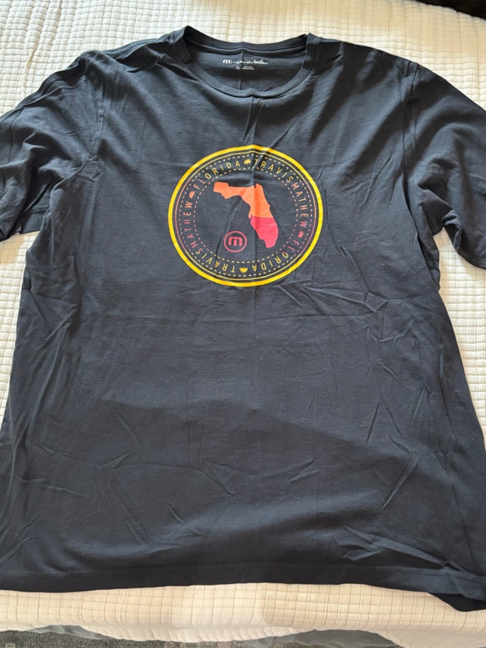 Travis Mathew Black Short Sleeve Tee with Orange and Red Florida Crest